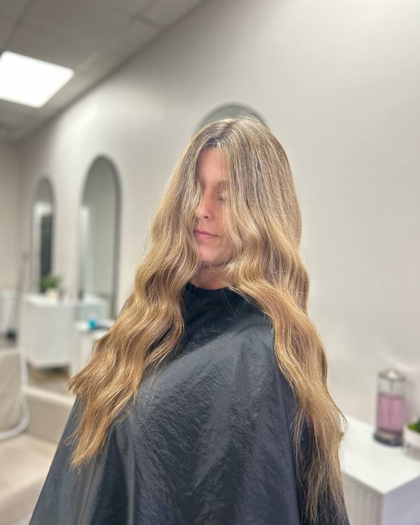 Long blonde waves with a darker root