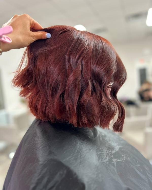 A rich red, cut into a wavy bob