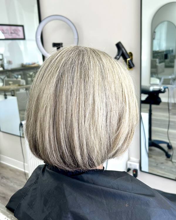A smooth blonde bob with a soft curve