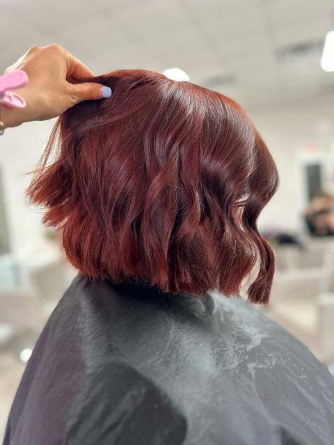 A rich red, cut into a wavy bob