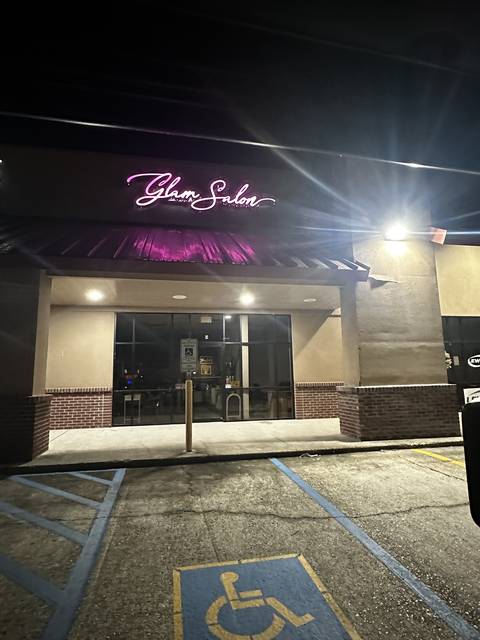 Our storefront at night with the pink neon sign
